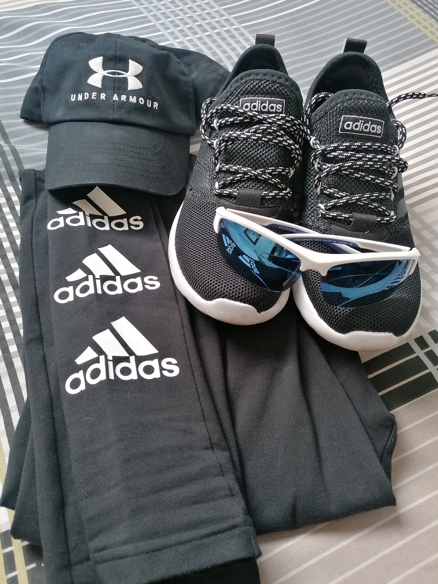 Adidas trousers, under armour hat, adidas running shoes